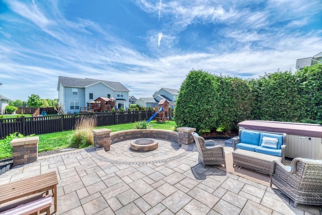 141 Bluegrass Pkwy, Oswego, IL 60543 - view of patio / terrace with a playground, a fenced backyard, a residential view, a hot tub, and an outdoor living space with a fire pit
