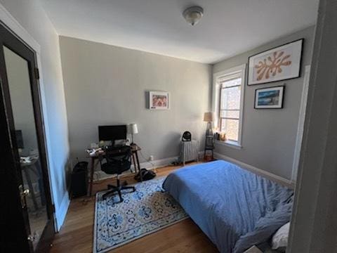 5110 S Woodlawn Ave Unit 3H, Chicago, IL 60615 - bedroom with radiator heating unit, wood finished floors, baseboards, and a desk