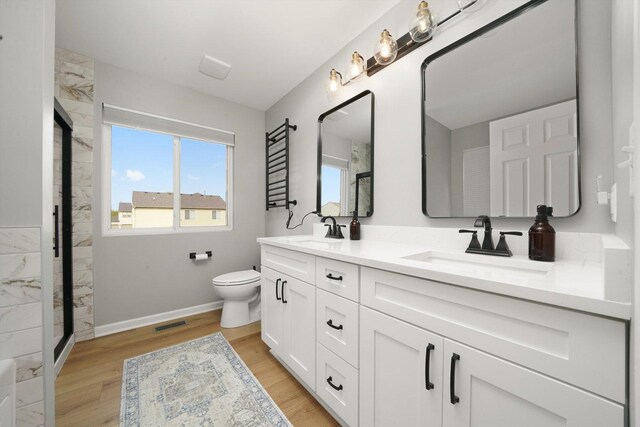 14530 General Dr, Plainfield, IL 60544 - full bath with toilet, double vanity, wood finished floors, and baseboards