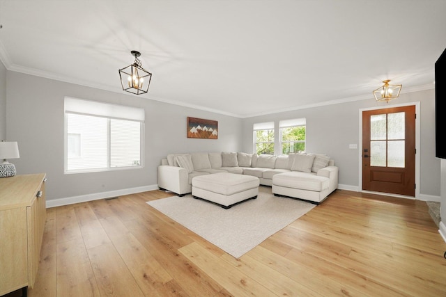 14530 General Dr, Plainfield, IL 60544 - living area featuring a chandelier, light wood-type flooring, baseboards, and crown molding