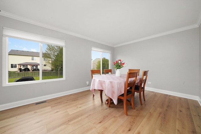 14530 General Dr, Plainfield, IL 60544 - dining room with wood finished floors, ornamental molding, and baseboards