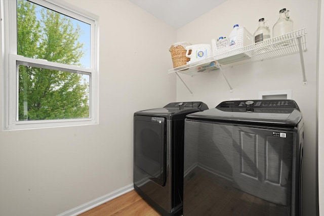 14530 General Dr, Plainfield, IL 60544 - laundry room featuring separate washer and dryer, light wood-type flooring, plenty of natural light, and baseboards