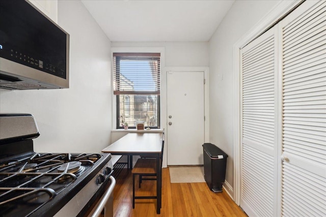 kitchen with stainless steel appliances and light wood-style flooring