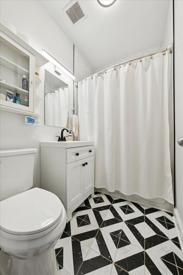 full bathroom featuring toilet, vanity, and curtained shower