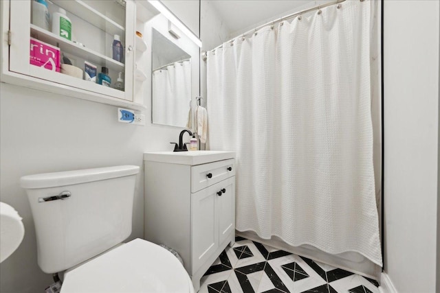 full bathroom with toilet and vanity
