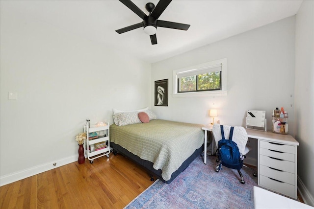 bedroom with wood finished floors, ceiling fan, and baseboards