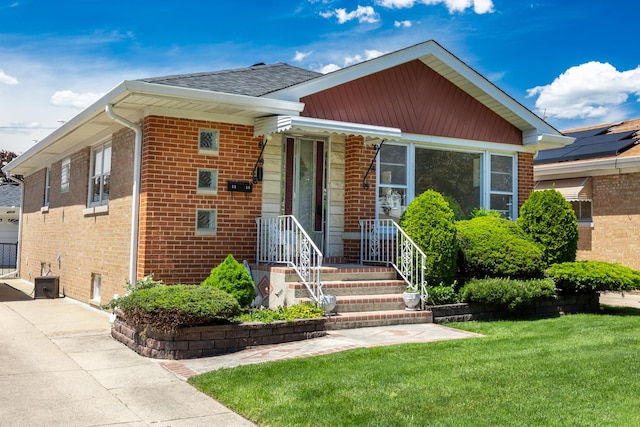 4316 N Sayre Ave, Norridge, IL 60706 - view of front of home with brick siding, a front lawn, and a shingled roof