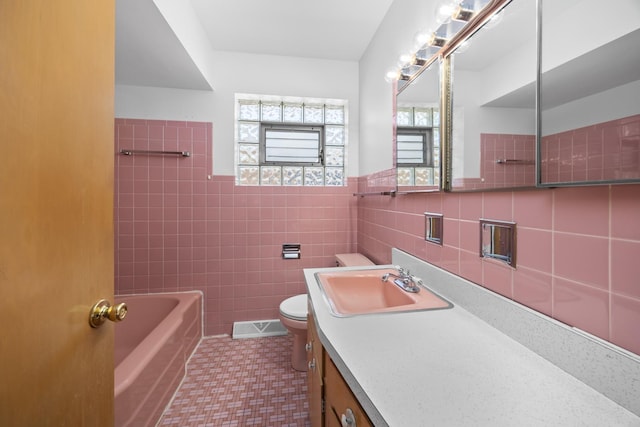 4316 N Sayre Ave, Norridge, IL 60706 - bathroom with toilet, tile walls, vanity, tile patterned flooring, and wainscoting