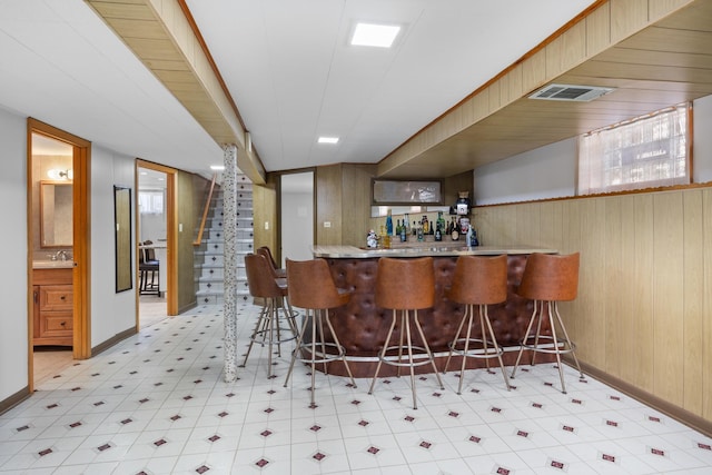 4316 N Sayre Ave, Norridge, IL 60706 - indoor dry bar featuring light flooring, wooden walls, stairway, and baseboards
