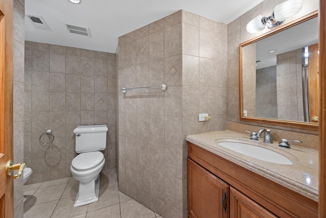 4316 N Sayre Ave, Norridge, IL 60706 - bathroom featuring tile walls, toilet, tile patterned flooring, and vanity