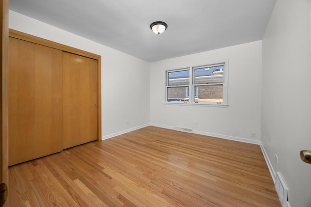 4316 N Sayre Ave, Norridge, IL 60706 - unfurnished bedroom featuring light wood-style flooring, baseboards, and a closet