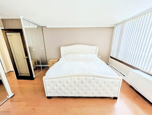 6171 N Sheridan Rd Unit 402, Chicago, IL 60660 - bedroom with light wood-style flooring, crown molding, and baseboard heating