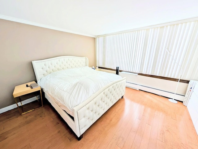 6171 N Sheridan Rd Unit 402, Chicago, IL 60660 - bedroom with ornamental molding, light wood-type flooring, and a baseboard heating unit