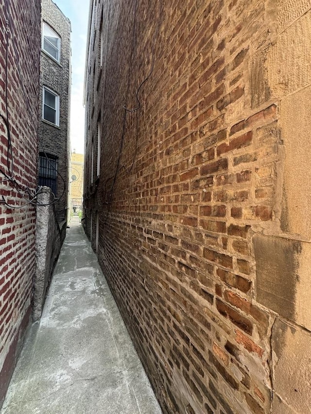view of side of home with brick siding