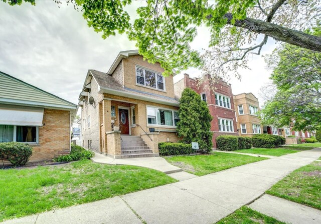 4510 N Menard Ave, Chicago, IL 60630 - view of front facade featuring brick siding and a front yard