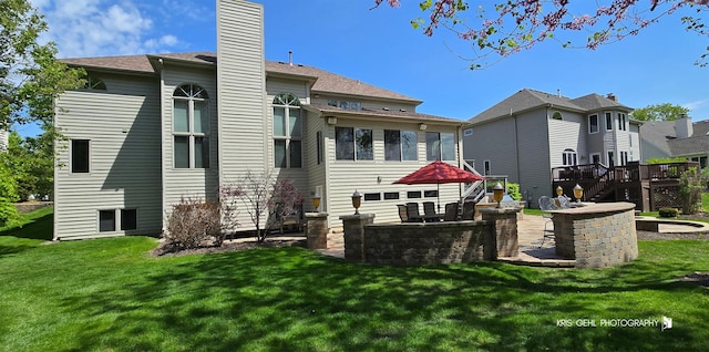 2653 Clara Ave, Aurora, IL 60502 - back of property with a chimney, a yard, a wooden deck, and stairway