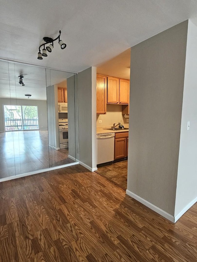 4B Kingery Quarter Unit 206, Willowbrook, IL 60527 - kitchen featuring white appliances, dark wood-style floors, a sink, open floor plan, and baseboards