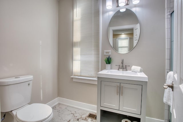 4170 W Cornelia Ave, Chicago, IL 60641 - bathroom with marble look tiles, toilet, baseboards, and vanity