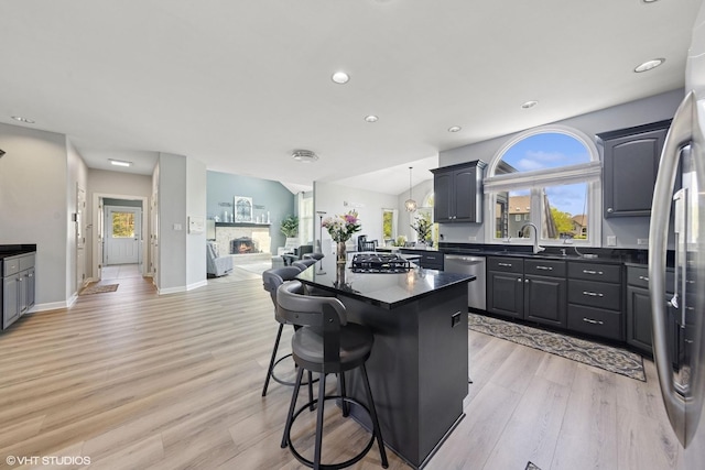4276 Colton Cir, Naperville, IL 60564 - kitchen with stainless steel appliances, dark countertops, a center island, light wood-type flooring, and recessed lighting