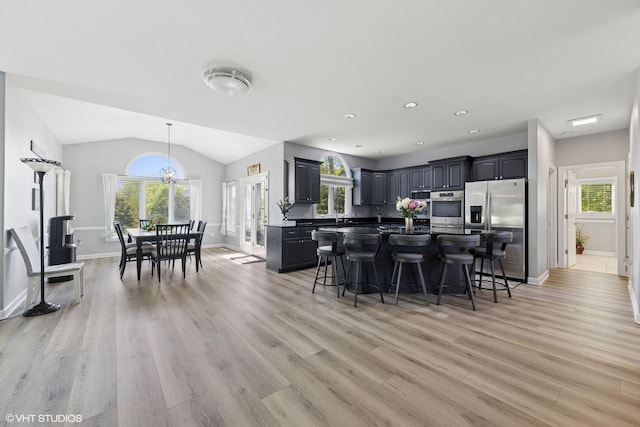 4276 Colton Cir, Naperville, IL 60564 - kitchen featuring appliances with stainless steel finishes, a kitchen breakfast bar, healthy amount of natural light, recessed lighting, and lofted ceiling