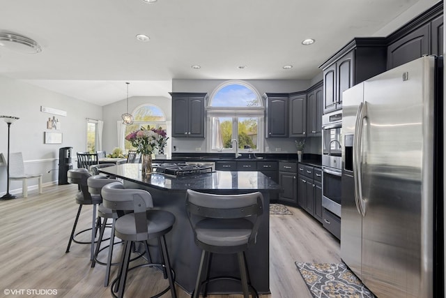 4276 Colton Cir, Naperville, IL 60564 - kitchen featuring appliances with stainless steel finishes, light wood finished floors, a breakfast bar area, a center island, and recessed lighting