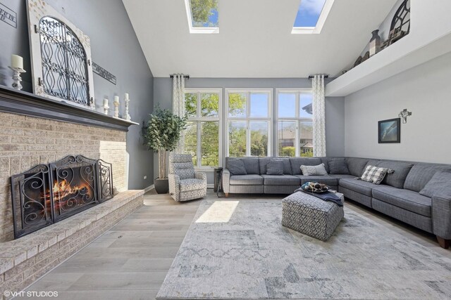 4276 Colton Cir, Naperville, IL 60564 - living room featuring a skylight, high vaulted ceiling, wood finished floors, and a brick fireplace