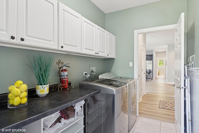 4276 Colton Cir, Naperville, IL 60564 - laundry room featuring independent washer and dryer, cabinet space, and light tile patterned floors