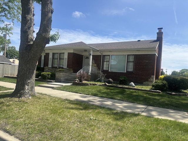 8425 S Spaulding Ave, Chicago, IL 60652 - view of front of home with brick siding, a front yard, and a chimney