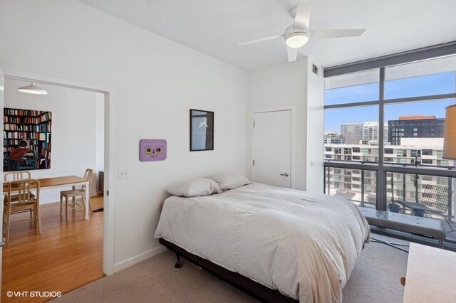 303 W Ohio St Unit 1509, Chicago, IL 60654 - bedroom with floor to ceiling windows, a city view, and baseboards