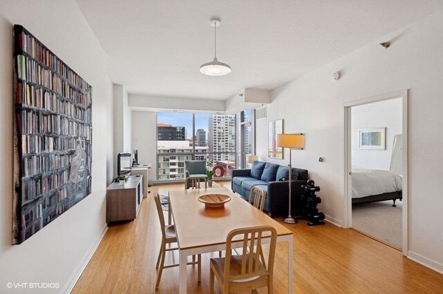 303 W Ohio St Unit 1509, Chicago, IL 60654 - dining space featuring light wood-type flooring and baseboards