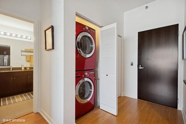 303 W Ohio St Unit 1509, Chicago, IL 60654 - washroom with stacked washer / drying machine, light wood-type flooring, and baseboards
