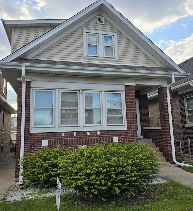 view of front of home featuring brick siding