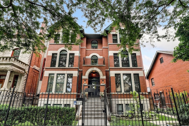 2117 W Evergreen Ave Unit 3E, Chicago, IL 60622 - view of front of home with a fenced front yard, brick siding, and a gate
