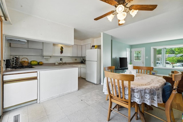 1724 Sycamore Ave, Hanover Park, IL 60133 - kitchen featuring freestanding refrigerator, a ceiling fan, light countertops, and white cabinets