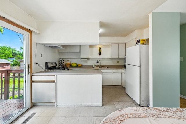 1724 Sycamore Ave, Hanover Park, IL 60133 - kitchen with freestanding refrigerator, stainless steel range with gas stovetop, light countertops, a peninsula, and light tile patterned floors