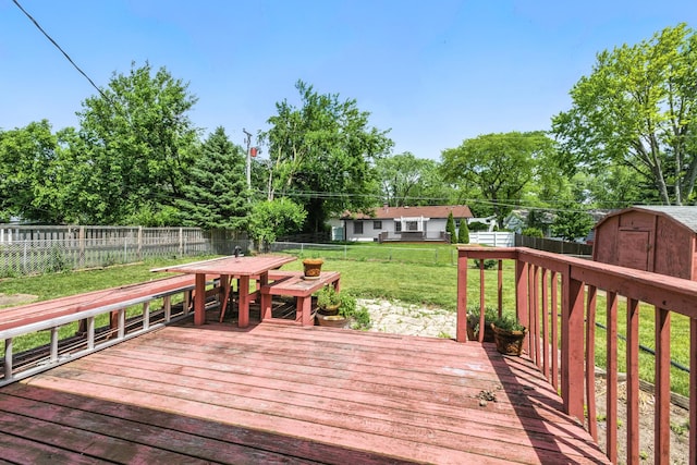 1724 Sycamore Ave, Hanover Park, IL 60133 - wooden deck featuring a fenced backyard, a storage unit, outdoor dining space, and view of wooded area
