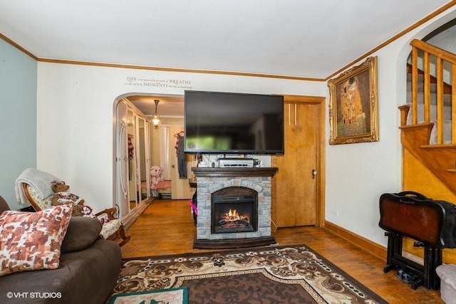 9230 S Saint Louis Ave, Evergreen Park, IL 60805 - living area with wood finished floors, crown molding, arched walkways, stairs, and a stone fireplace