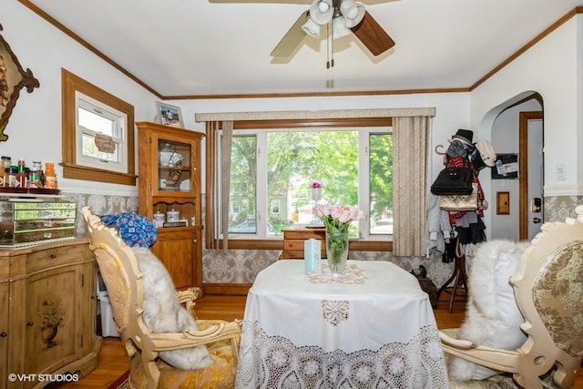 9230 S Saint Louis Ave, Evergreen Park, IL 60805 - dining room with light wood finished floors, ceiling fan, crown molding, and arched walkways