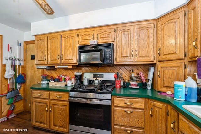 9230 S Saint Louis Ave, Evergreen Park, IL 60805 - kitchen featuring stainless steel gas stove, black microwave, brown cabinetry, and dark countertops