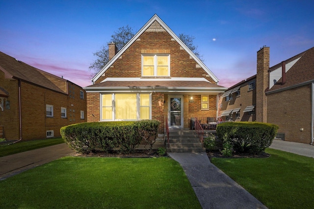 9656 S Utica Ave, Evergreen Park, IL 60805 - view of front of home with a porch, a lawn, and brick siding