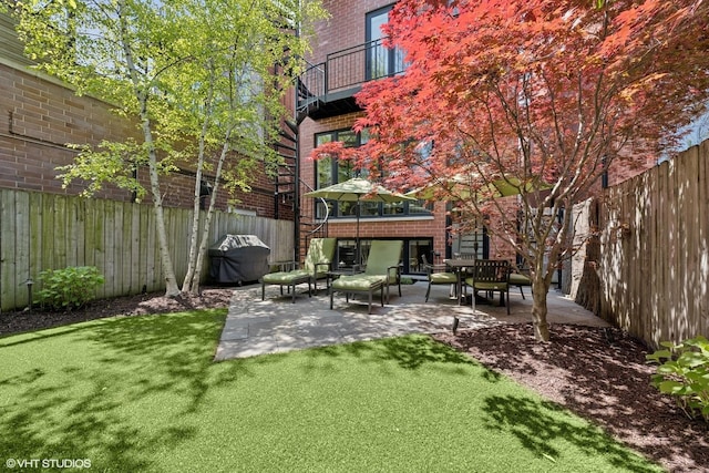 view of yard with a patio area and a balcony