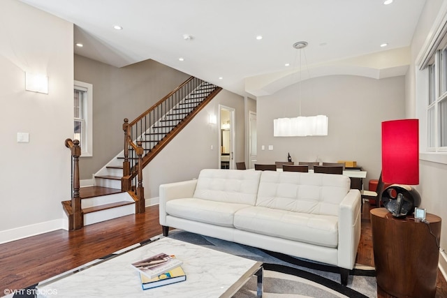 living area with wood finished floors, stairs, recessed lighting, and baseboards