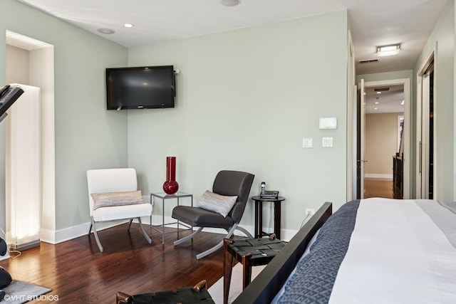 bedroom featuring wood finished floors, baseboards, and recessed lighting