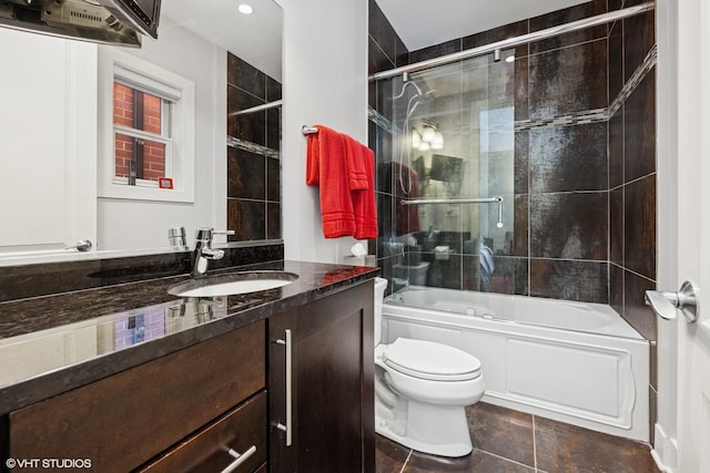 full bathroom with vanity, toilet, enclosed tub / shower combo, and tile patterned floors