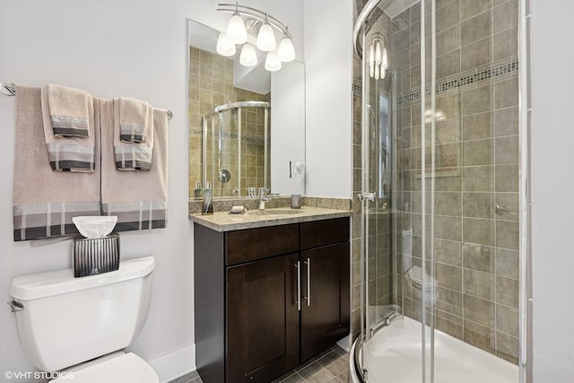 full bathroom with a shower stall, toilet, and vanity