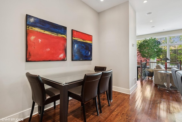 dining room featuring wood finished floors, baseboards, and recessed lighting