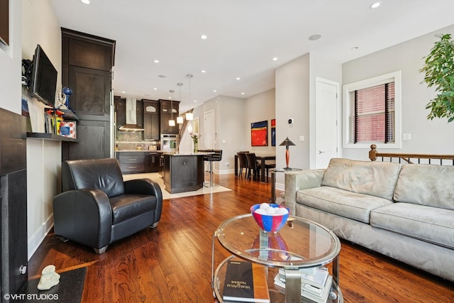 living area featuring dark wood-style floors, recessed lighting, and baseboards