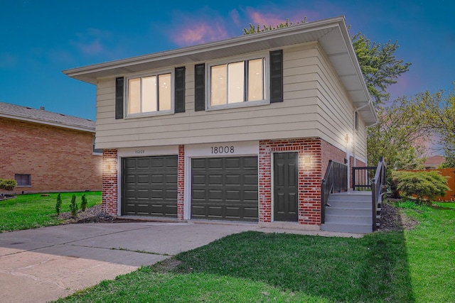 18008 Crawford Ave, Country Club Hills, IL 60478 - view of front facade with brick siding, an attached garage, a yard, and concrete driveway