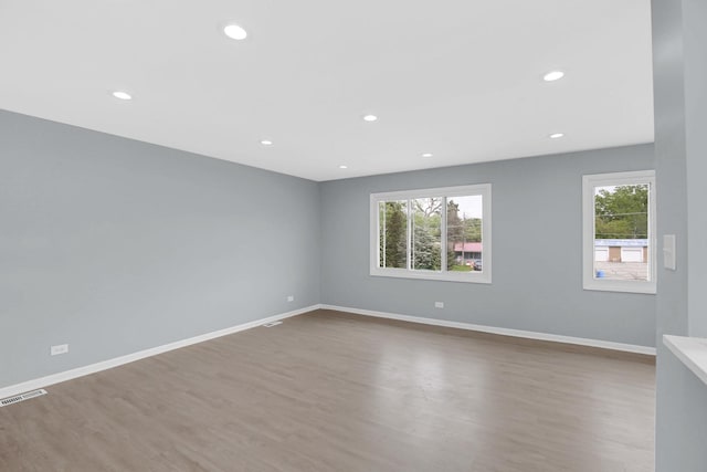 18008 Crawford Ave, Country Club Hills, IL 60478 - empty room with healthy amount of natural light, wood finished floors, recessed lighting, and baseboards