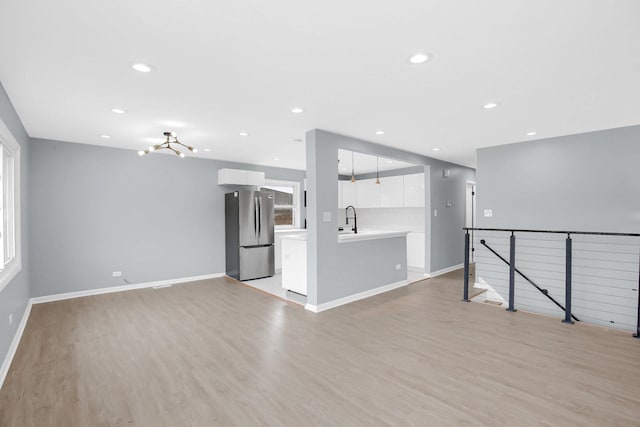 18008 Crawford Ave, Country Club Hills, IL 60478 - unfurnished living room featuring light wood finished floors, a sink, baseboards, and recessed lighting